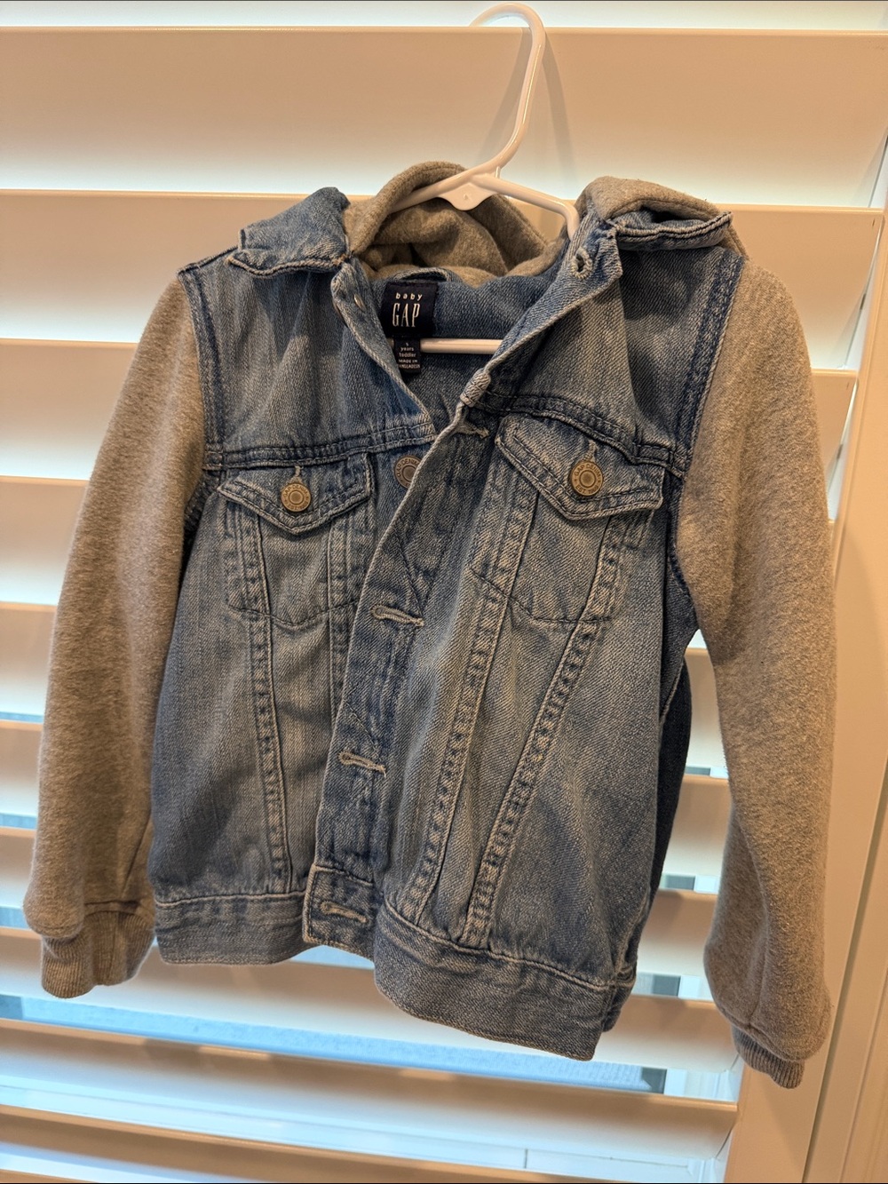 GAP Denim Jacket with Gray Hoodie Sleeves.